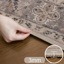Hand houdt de afgewerkte rand van het 3 mm dikke beige vloerkleed omhoog